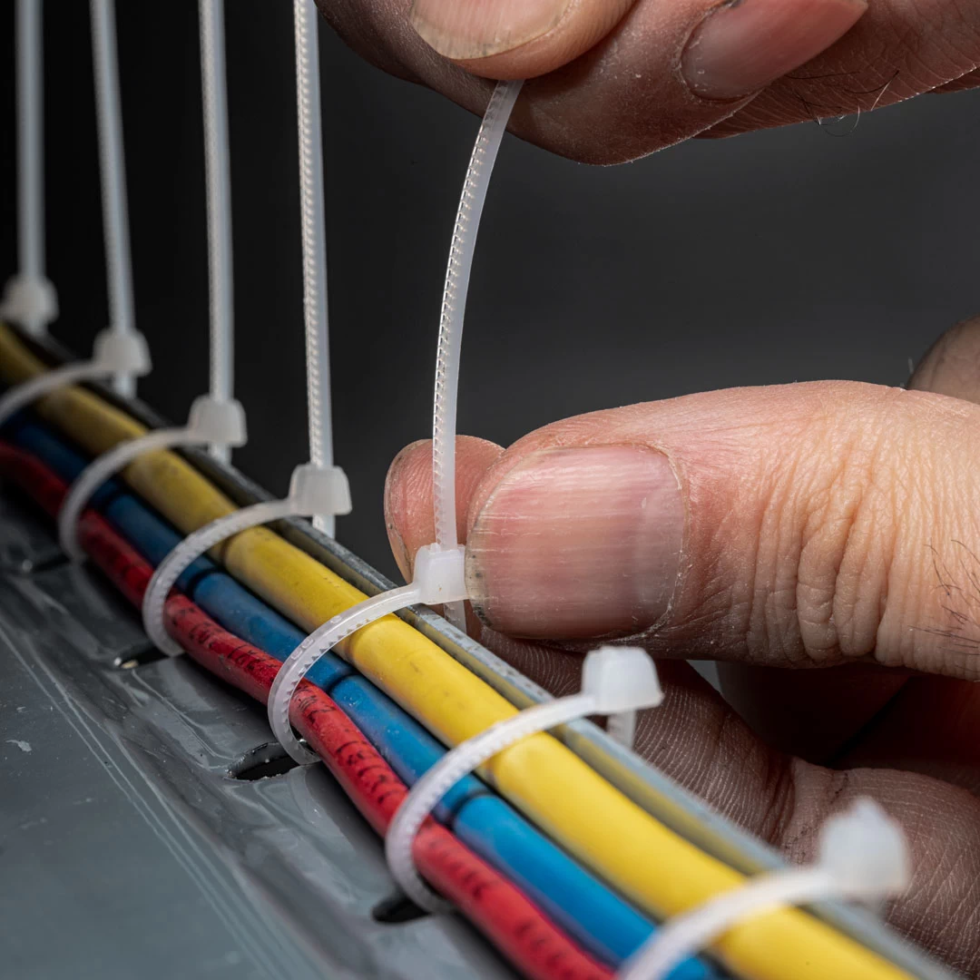white zip ties securing electrical cables for cable management