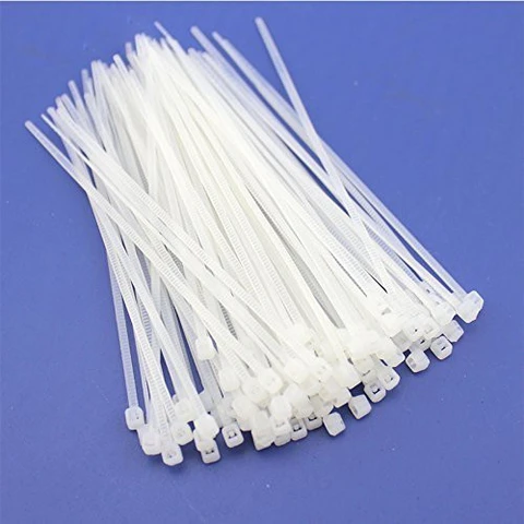 white zip ties pack on blue background for cable management and bundling
