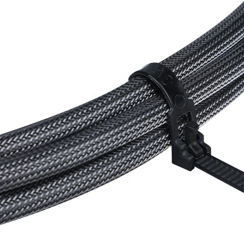 Black nylon zip tie securing braided cable sleeve bundle for industrial cable management and organized wiring protection in professional installations