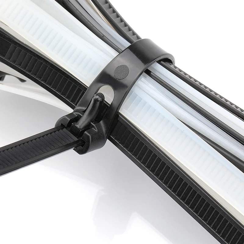 Black screw mount cable tie securing multiple cables on pipe showing nylon zip tie clamp used for industrial cable management and organized wiring installation system