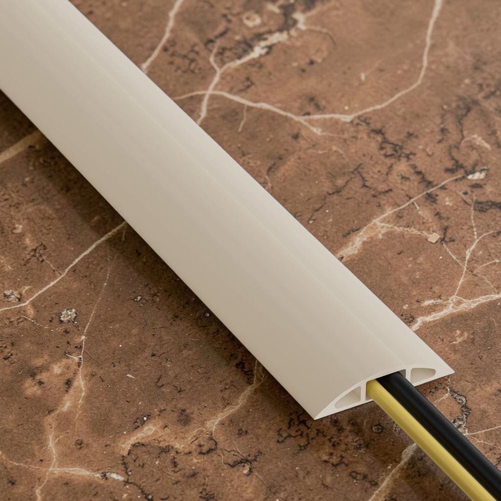 Beige cord cover protecting electrical cables on brown marble floor, sleek low profile cable management solution for home and office use