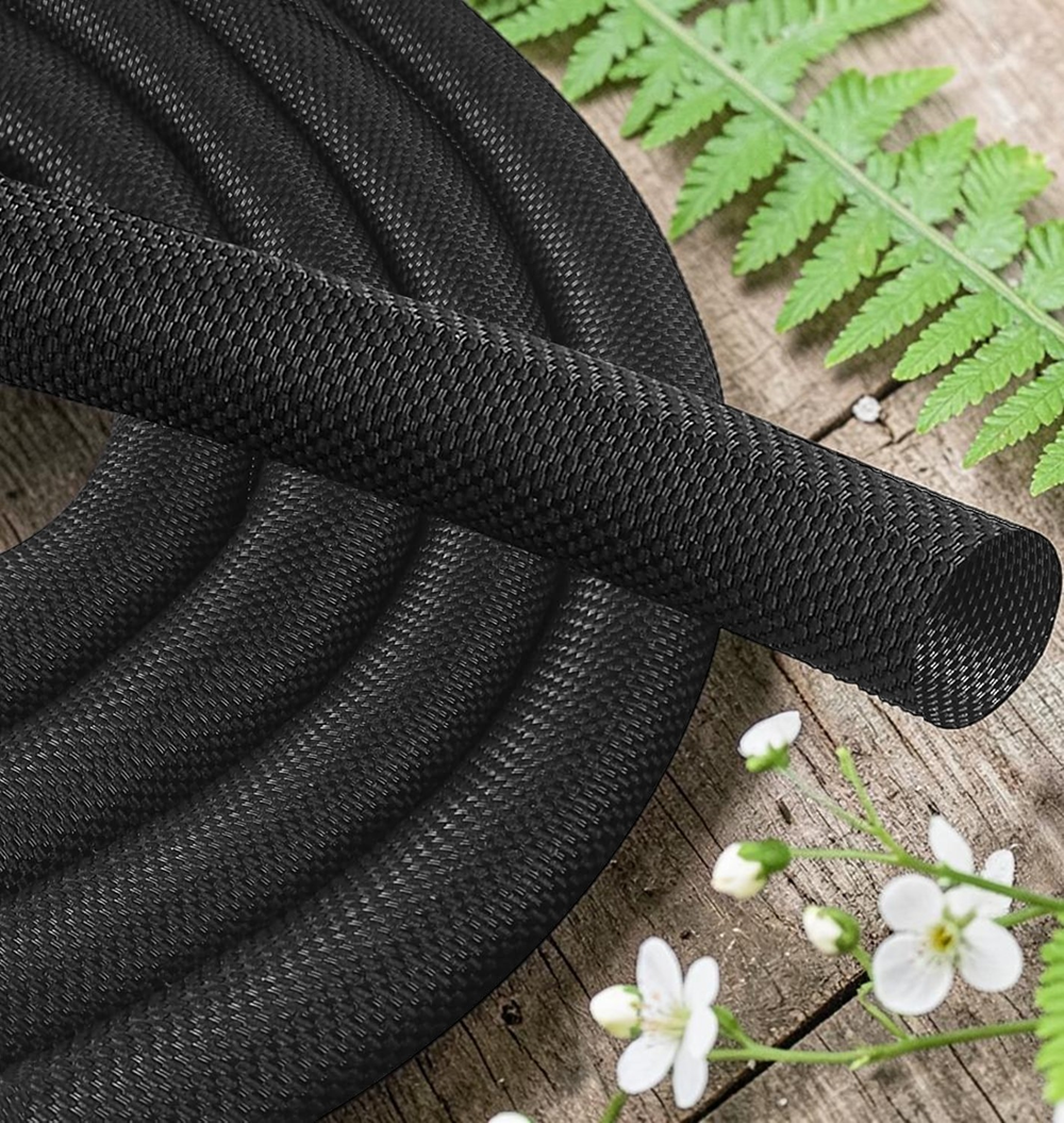 Close-up view of black braided cable management sleeve showing durable woven texture and flexible wire protection design.