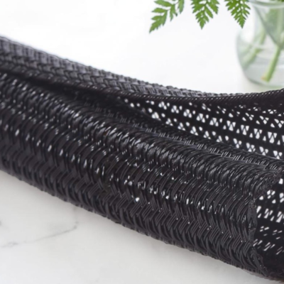 Black expandable braided cable sleeve for wire management and cable protection, flexible mesh sleeving for organizing electrical cables and wiring.