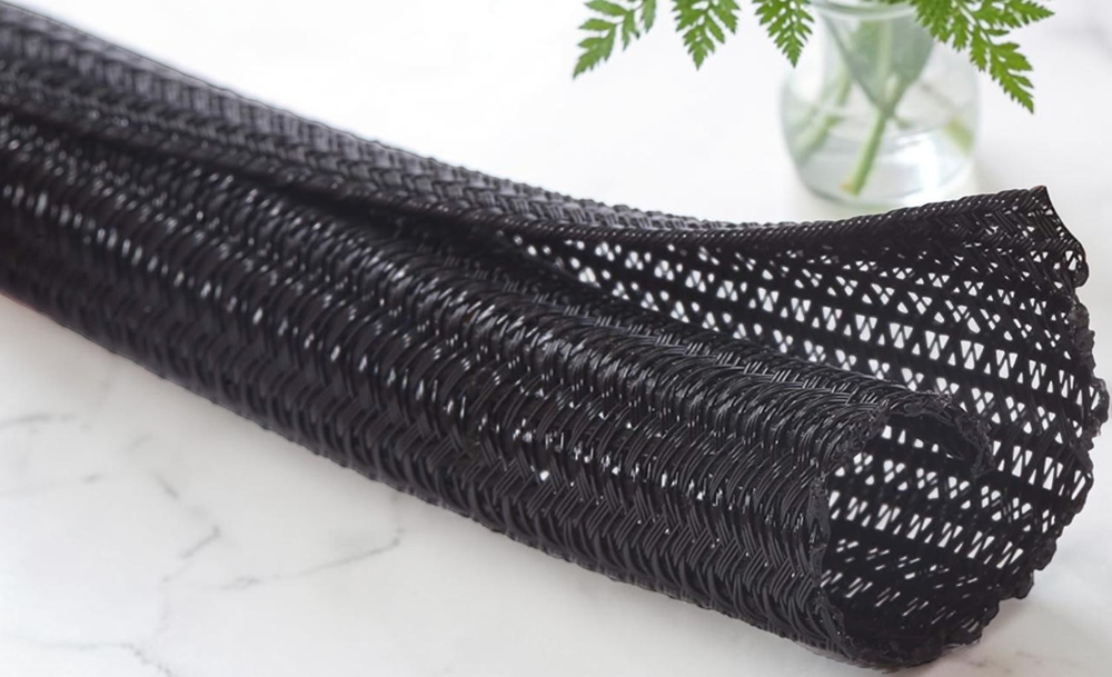 Black expandable braided cable sleeve for wire management and cable protection, flexible mesh sleeving for organizing electrical cables and wiring.
