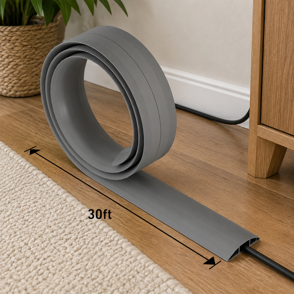 Grey 30ft cord cover cable protector displayed on a wooden floor in a modern home interior, providing neat wire management and protection for floor cables