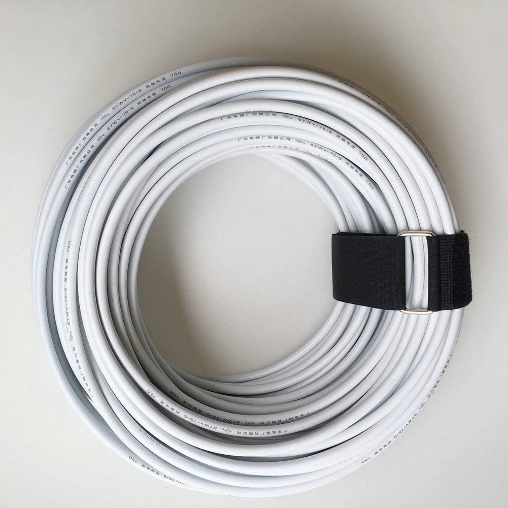 White electrical cable neatly coiled and secured with a black hook and loop strap, demonstrating cable organization and storage.