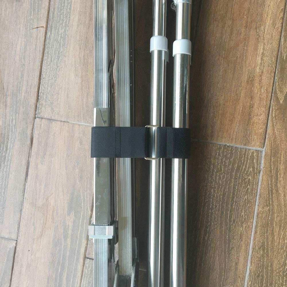 Hook and loop strap securing metal poles together, showing reusable cable management solution.