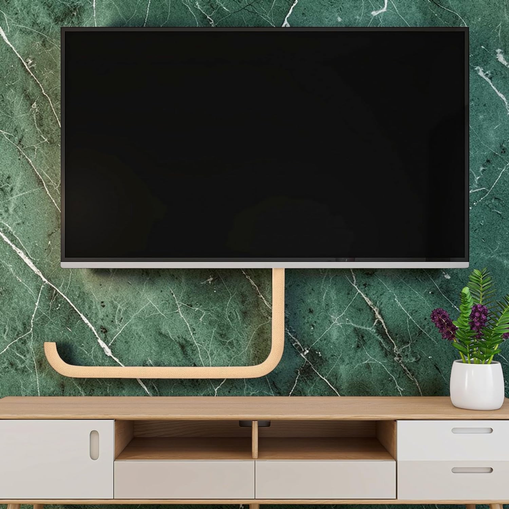 Wall-mounted TV setup with cable management sleeve organizing wires below the screen in a modern living room.