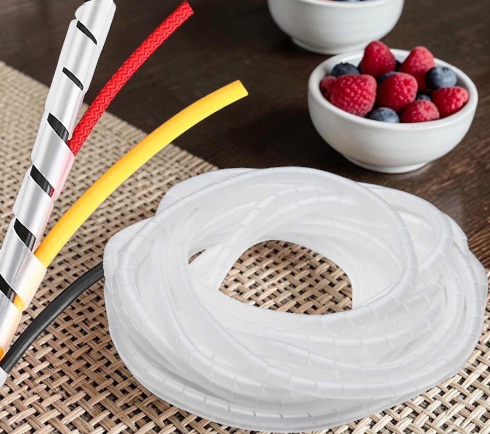 White cable management sleeve organizer with flexible wire wrap tubing for protecting and bundling multiple cables on a home desk setup