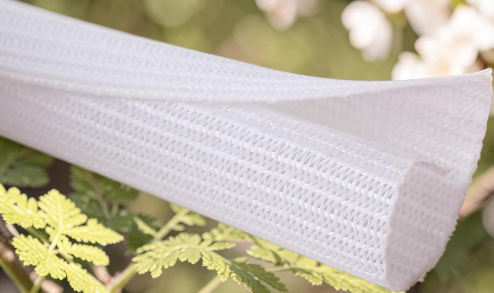 White expandable braided cable sleeve with flexible mesh design for cable management, wire organization, and electrical cable protection.